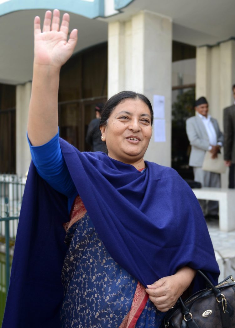 Nepalese presidential candidate nominated by the Communist Party of Nepal (Unified Marxist-Leninist) (CPN-UML), Bidhya Bhandari, waves after casting her vote in an election for Nepal's new president in Kathmandu on October 28, 2015. The legislature was to vote on October 28 for a replacement for Ram Baran Yadav as ceremonial head of state, as required under the new constitution adopted last month. AFP PHOTO / Prakash MATHEMA